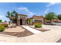 Charming single-story home with desert landscaping, stone columns, and a two car garage at 17664 W Marshall Ln, Surprise, AZ 85388