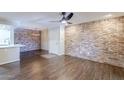 Spacious living room boasting wood floors, brick accent wall, and plenty of natural light at 2025 E Campbell Ave # 143, Phoenix, AZ 85016