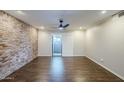 Well-lit living room features wood flooring, ceiling fan, and access to a private balcony at 2025 E Campbell Ave # 143, Phoenix, AZ 85016