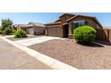 View of the home within its neighborhood setting, showcasing easy street access and neat landscaping at 2176 W Larissa Ln, San Tan Valley, AZ 85144