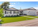 Attractive home exterior with manicured lawn and inviting patio seating, showcasing a welcoming and well-maintained facade at 2316 N 81St St, Scottsdale, AZ 85257