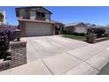 Charming two-story home features a brick facade, a two-car garage, and well-maintained landscaping at 23833 N 36Th Dr, Glendale, AZ 85310