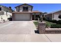 Charming two-story home features a brick facade, a two-car garage, and well-maintained landscaping at 23833 N 36Th Dr, Glendale, AZ 85310