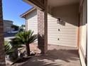 Inviting covered front porch with brick columns, mature landscaping, and a peaceful ambiance at 23833 N 36Th Dr, Glendale, AZ 85310