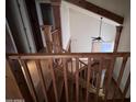 Spacious staircase, enhanced by wooden accents, offers views of the downstairs living area and tall ceilings at 23833 N 36Th Dr, Glendale, AZ 85310