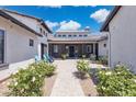 Charming courtyard with string lights, fountain, blue chairs, and lush white flowering landscaping at 2630 E Lovebird Ln, Gilbert, AZ 85297