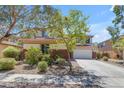 Lovely home with a two-car garage, well-maintained landscaping, and beautiful trees in the front yard at 27053 N 172Nd Ln, Surprise, AZ 85387