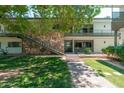 Charming two-story condo with stone accents, stairs to the second level, and lush landscaping at 330 W Maryland Ave # 207, Phoenix, AZ 85013