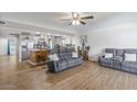 Open concept living space with kitchen view, tile flooring, and comfortable seating area at 4822 N 63Rd Ln, Phoenix, AZ 85033
