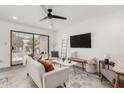 Bright living room with modern decor, ceiling fan, and sliding glass doors at 515 S Saguaro Way, Mesa, AZ 85208