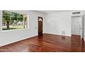 Spacious living room featuring hardwood flooring and a large window at 522 W Cambridge Ave, Phoenix, AZ 85003