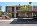 Apartment complex with covered parking, outdoor staircases, brick supports, and mature landscaping at 5246 N 20Th St # B1, Phoenix, AZ 85016