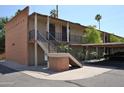 Apartment complex with covered parking, outdoor staircases, brick supports and manicured landscaping at 5246 N 20Th St # B1, Phoenix, AZ 85016