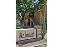Apartment building with complex address signage, brick facade, cacti, and mature trees at 5246 N 20Th St # B1, Phoenix, AZ 85016