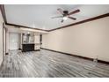 Spacious living room with modern wood-look floors and stylish ceiling fan at 7126 N 19Th Ave # 228, Phoenix, AZ 85021