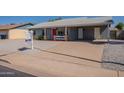 Single-story home featuring desert landscaping and a covered carport on a sunny day at 719 W Pampa Ave, Mesa, AZ 85210