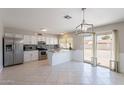 Bright kitchen featuring white cabinets, stainless steel appliances, and access to the backyard at 719 W Pampa Ave, Mesa, AZ 85210