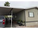 Charming tan home with covered parking and a ramp leading to the front door for easy accessibility at 8218 S 7Th St # Ofc, Phoenix, AZ 85042
