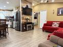 Open-concept living area with wood-look floors, modern furnishings, and a view into the kitchen at 8218 S 7Th St # Ofc, Phoenix, AZ 85042