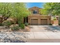Charming two-story home showcasing a well-manicured lawn and a spacious three-car garage at 8447 W Tether Trl, Peoria, AZ 85383