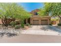 Charming two-story home showcasing a well-manicured lawn and a spacious three-car garage at 8447 W Tether Trl, Peoria, AZ 85383