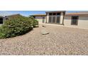 Exterior view of a home with well-maintained landscaping featuring gravel and mature shrubs at 8840 E Sunland Ave # 142, Mesa, AZ 85208