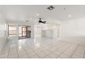 Bright and airy living room with white tile flooring, a ceiling fan, and sliding glass doors at 8884 E Arizona Park Pl, Scottsdale, AZ 85260