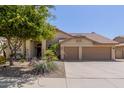 Charming single-story home with a well-maintained yard, desert landscaping, and a two-car garage at 10794 S Coolwater Dr, Goodyear, AZ 85338