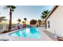 Backyard pool with palm trees and lounge chairs create a relaxing outdoor oasis for entertaining at 10794 S Coolwater Dr, Goodyear, AZ 85338