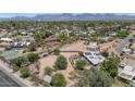 Aerial view of the neighborhood showcasing the lush landscaping, the many houses and the mountain backdrop at 12682 N 80Th Pl, Scottsdale, AZ 85260