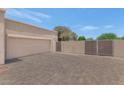 Desert home exterior with a garage and large driveway area at 12682 N 80Th Pl, Scottsdale, AZ 85260