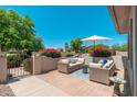Lovely outdoor patio featuring stylish seating, a brick-paver floor, and beautiful landscaping at 13034 W Krall Ct, Glendale, AZ 85307