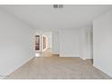 Spacious empty living room with neutral carpet, ready for customization at 1417 W Los Arboles Pl, Chandler, AZ 85224