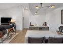 Entertaining space featuring a bar with marble countertops and a wine fridge near the seating area at 14518 N 99Th St, Scottsdale, AZ 85260
