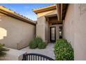 Charming front entrance with tiled patio and a welcoming front door, framed by lush landscaping at 14518 N 99Th St, Scottsdale, AZ 85260