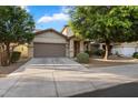 Charming single-story home featuring a neutral color scheme, well-maintained landscaping, and an attached two-car garage at 15844 W Lisbon Ln, Surprise, AZ 85379
