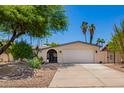 Charming single-story home with a two-car garage, desert landscaping, and mature trees offering curb appeal at 1743 W Acoma Dr, Phoenix, AZ 85023