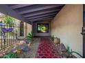 Inviting front porch features a colorful tiled pathway and decorative plants, leading to the front door at 1743 W Acoma Dr, Phoenix, AZ 85023