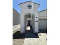 Inviting walkway leading to front door with arched entry at 19929 W Marshall Ave, Litchfield Park, AZ 85340