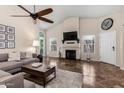 Spacious living room with a fireplace, ceiling fan, and lots of natural light at 20044 N 30Th Pl, Phoenix, AZ 85050