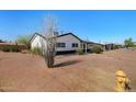 Cozy single-story home with easy street access, showcasing practical landscaping that enhances its accessibility and charm at 2204 E Birchwood Ave, Mesa, AZ 85204