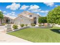 Charming home with a well-maintained lawn and vibrant landscaping at 2258 N Gentry --, Mesa, AZ 85213