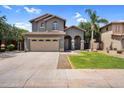 Two story home features a three car garage, desert landscaping, and an arched front entry at 3376 E Lafayette Ave, Gilbert, AZ 85298