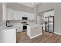 Bright kitchen features white cabinetry, stainless steel appliances, and a center island with quartz countertops at 3376 E Lafayette Ave, Gilbert, AZ 85298