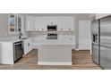 Bright kitchen features white cabinetry, stainless steel appliances, and a center island with quartz countertops at 3376 E Lafayette Ave, Gilbert, AZ 85298