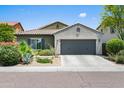 Single-story home with a two-car garage, showcasing well-maintained landscaping and a tile roof at 3766 E Ringtail Way, Phoenix, AZ 85050