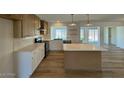Bright kitchen with island, pendant lights, and modern appliances at 3910 W Kings Ave, Phoenix, AZ 85053