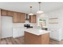 Well-lit kitchen showcases custom cabinetry, a stylish island, and stainless steel appliances at 3910 W Kings Ave, Phoenix, AZ 85053