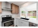 Close-up of a modern kitchen featuring stainless steel appliances and a view to the backyard at 3910 W Kings Ave, Phoenix, AZ 85053
