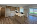Kitchen with kitchen island, modern appliances, and ample storage at 3910 W Kings Ave, Phoenix, AZ 85053